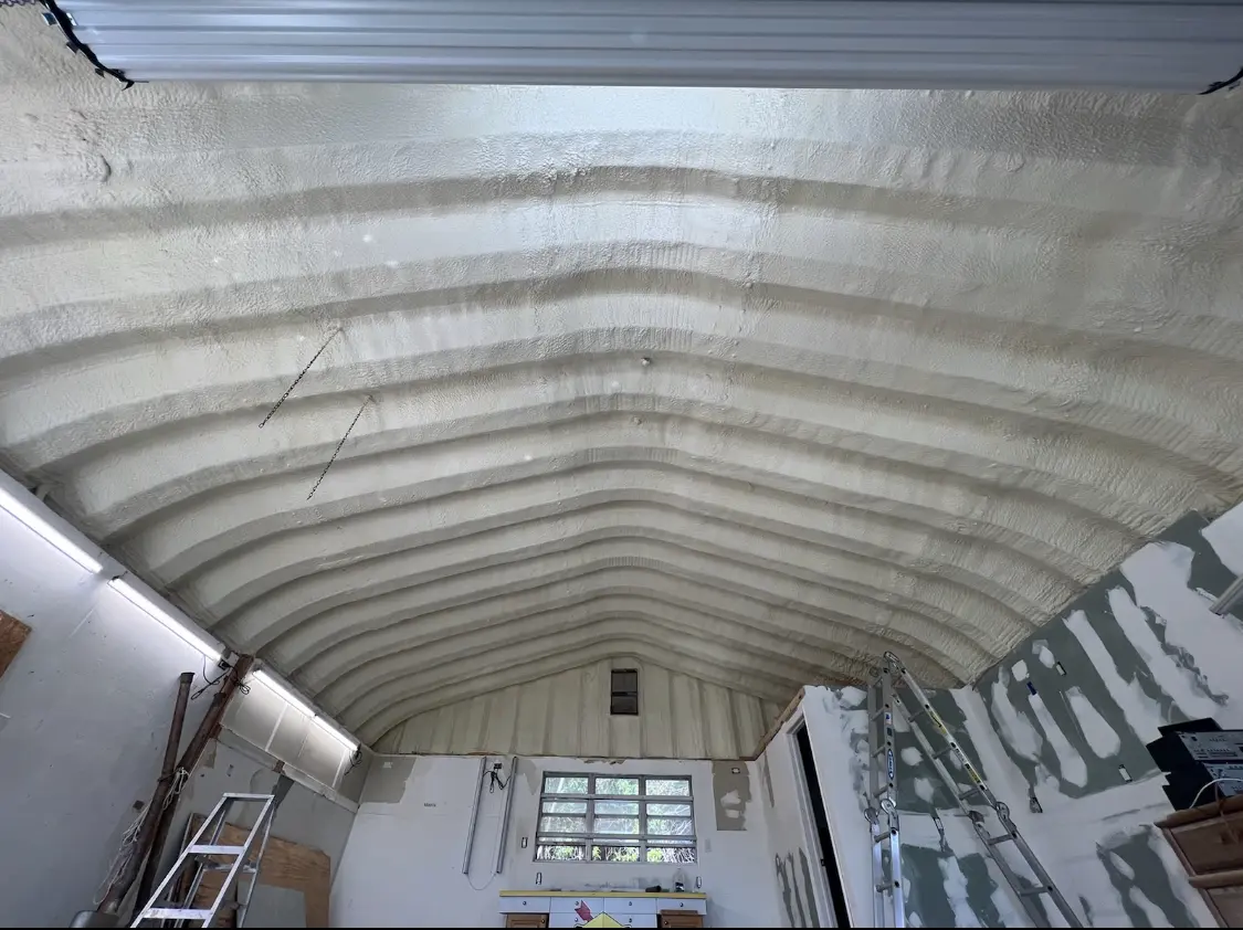 Spray polyurethane foam applied to the underside of a metal roof deck in Moyock